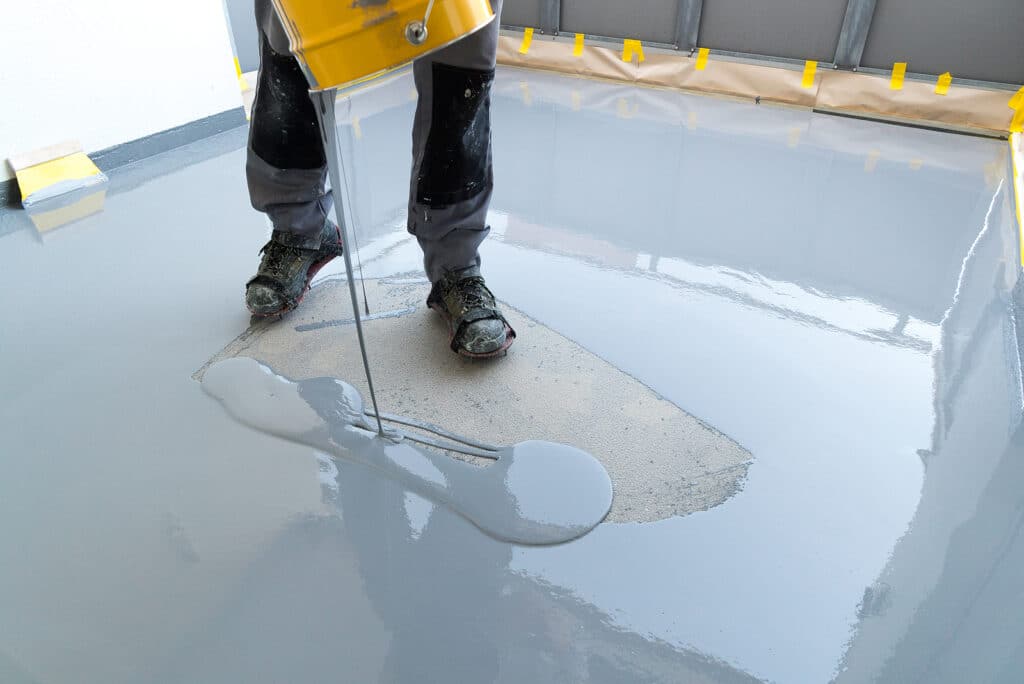 Construction worker pouring resin