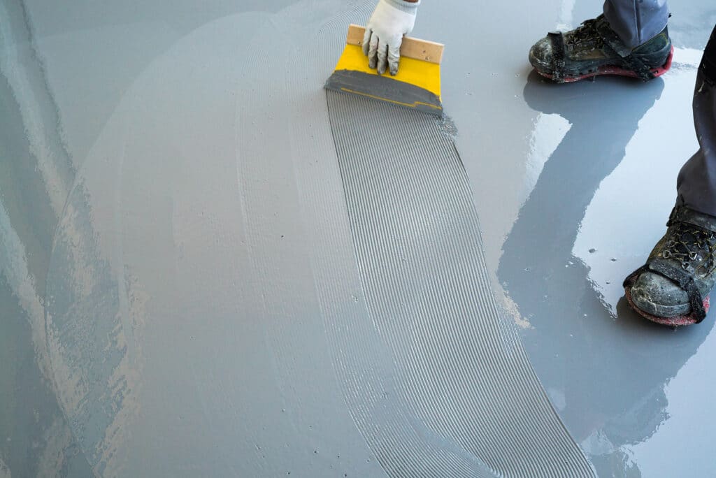 A construction working laying down a resin floor