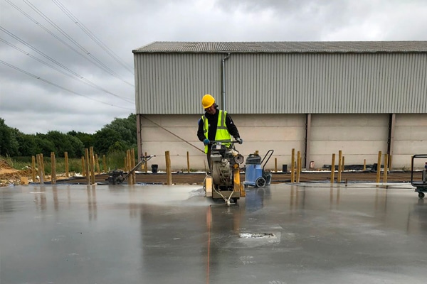 A builder laying industrial flooring