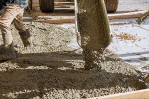 mixed concrete being poured onto the ground