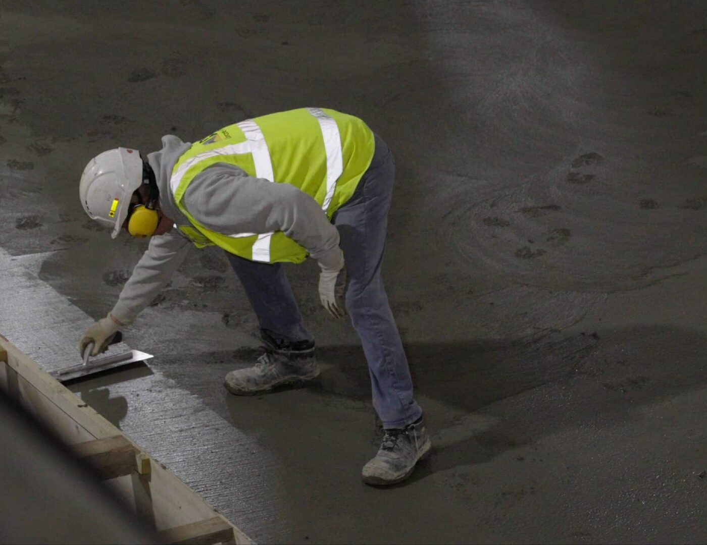 worker levelling concrete floor